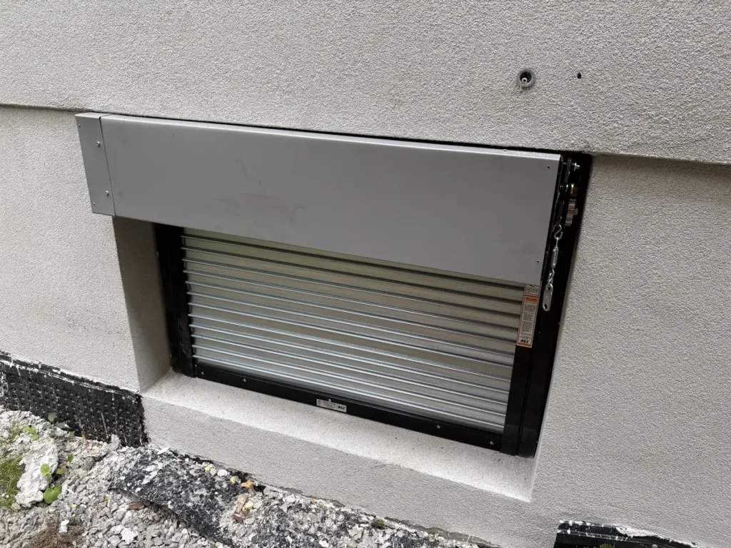 Fire-rated rolling shutter installed on a basement window of a Toronto new build