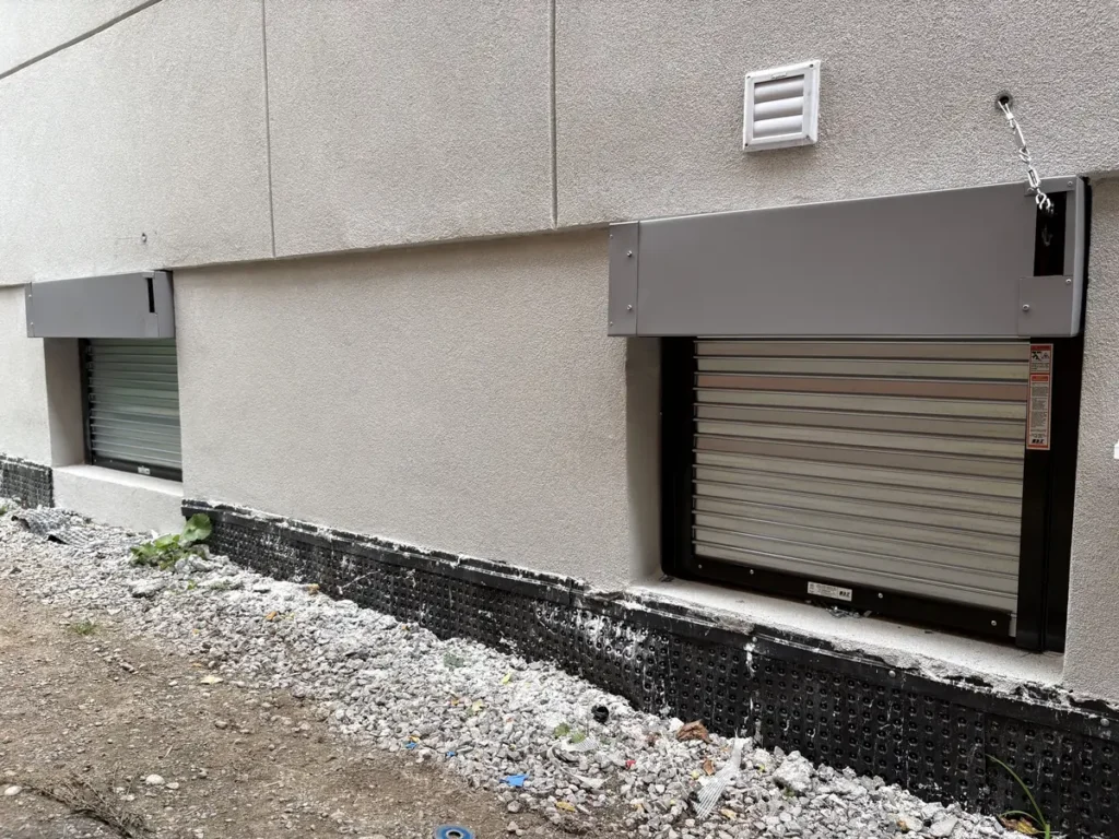 Two window fire shutters on the side wall of a new build home in Toronto