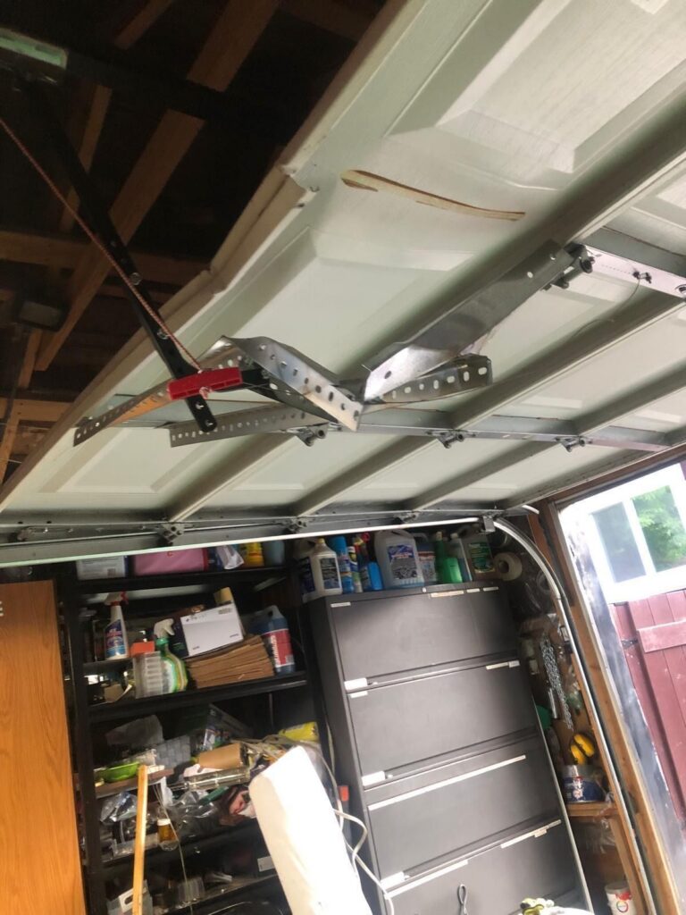 Garage door off track and hanging crooked, repaired by TBC Garage Doors in Toronto