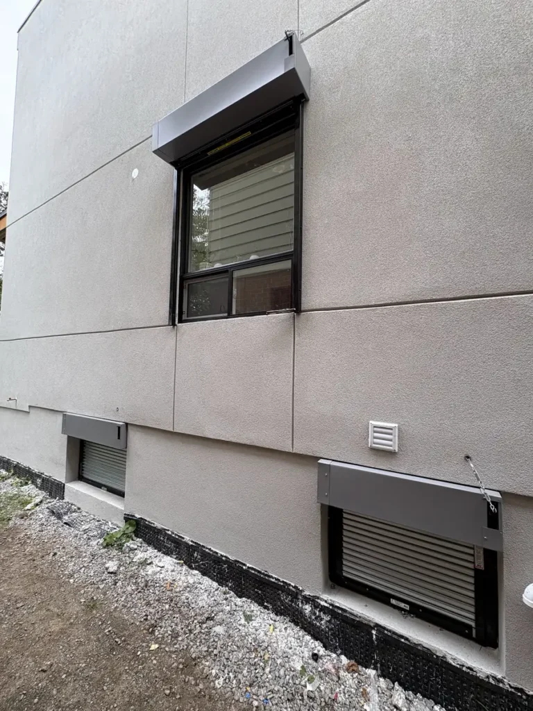 Window fire shutters on the upper and basement windows of a new construction home in Toronto
